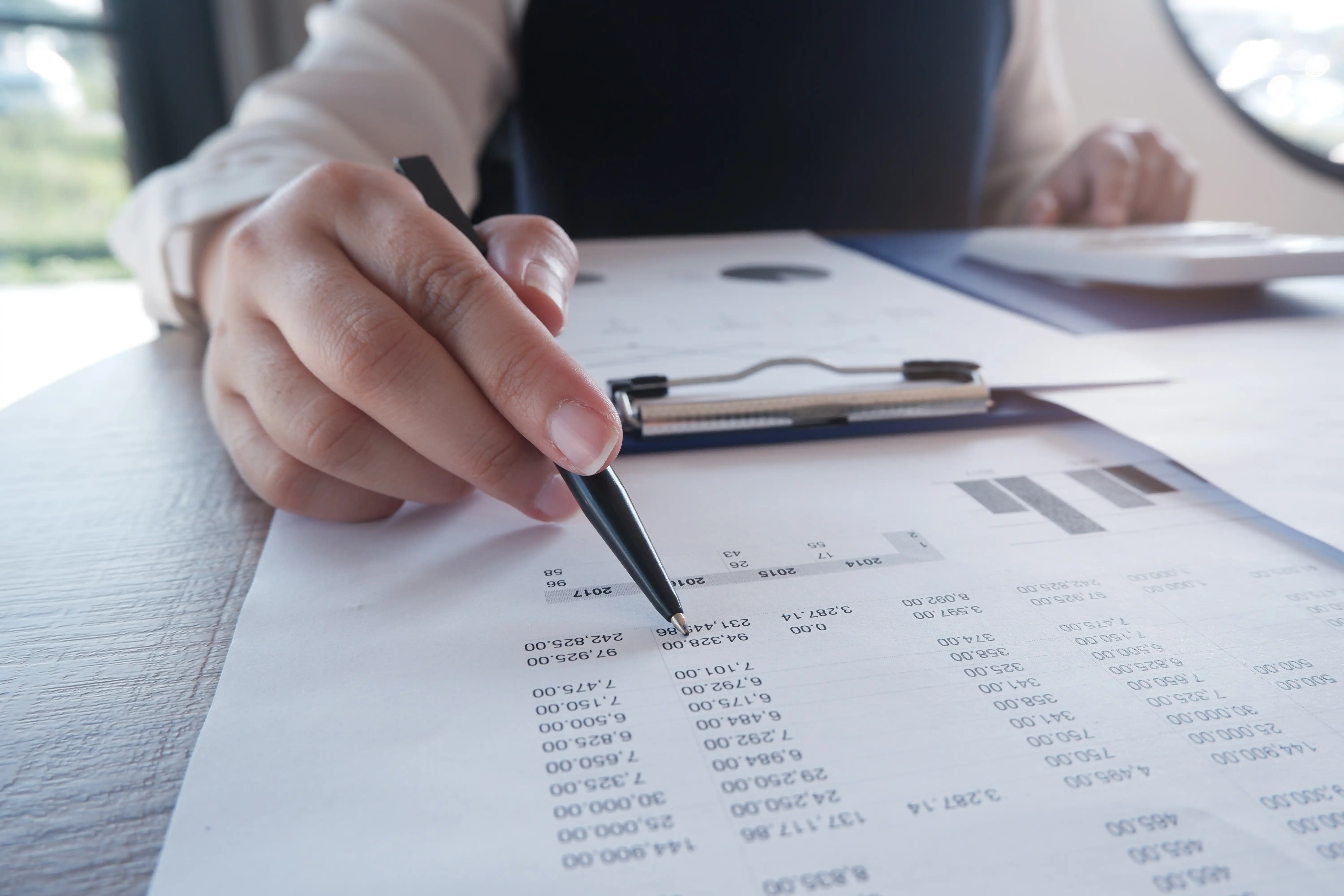 Employee reviewing itemized payroll records and tracking work hours on a spreadsheet to protect rights under California wage laws