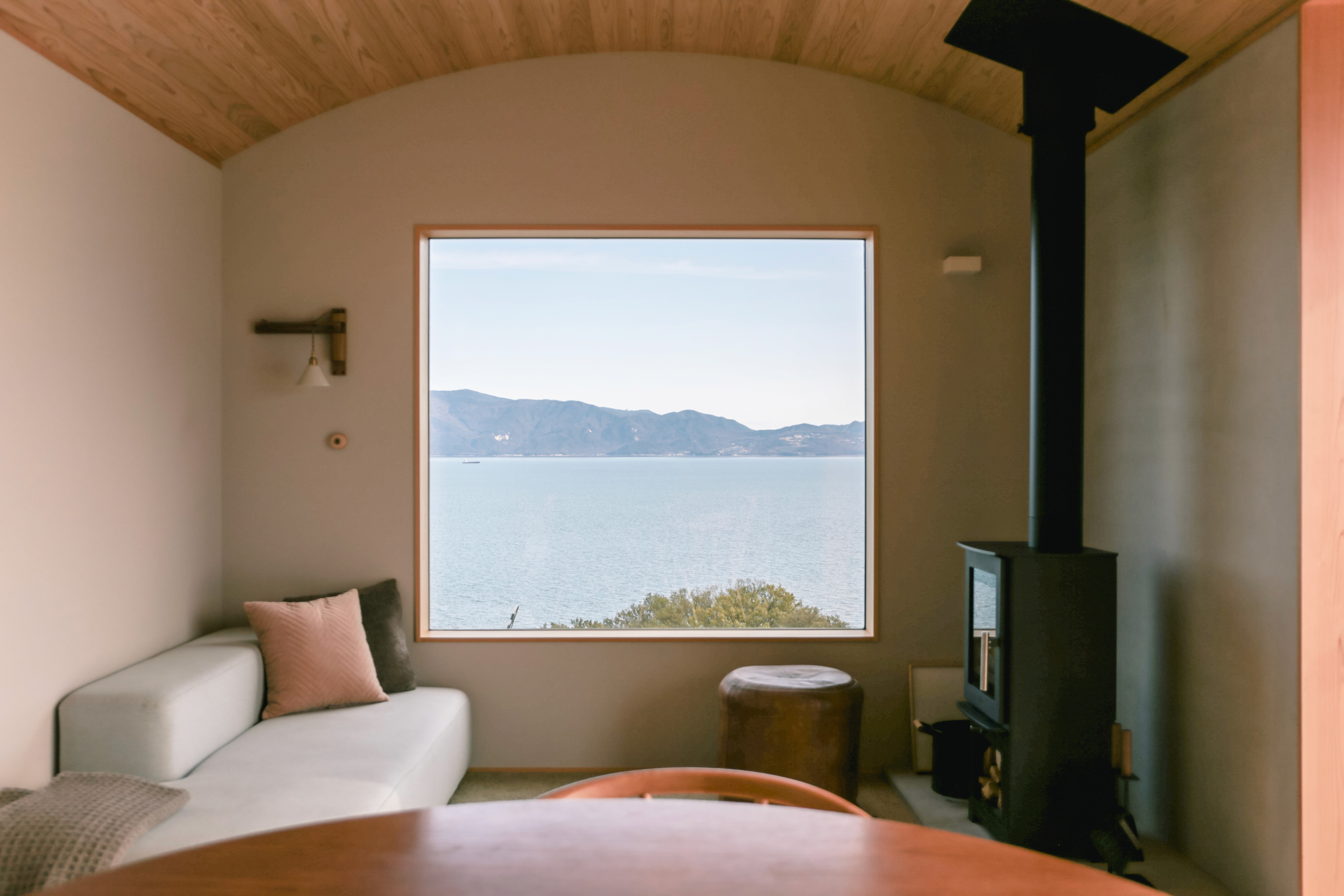 Interior of a room with a view of the sea and earthy tones for the interior color