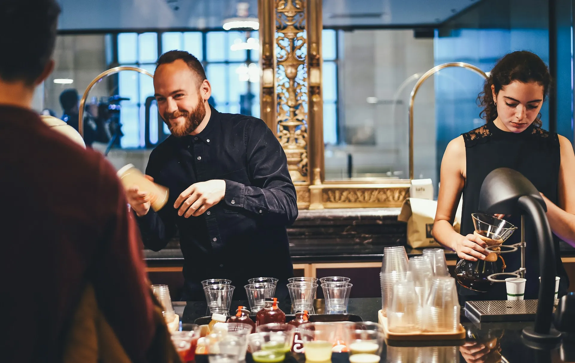 Bartenders working behind a bar