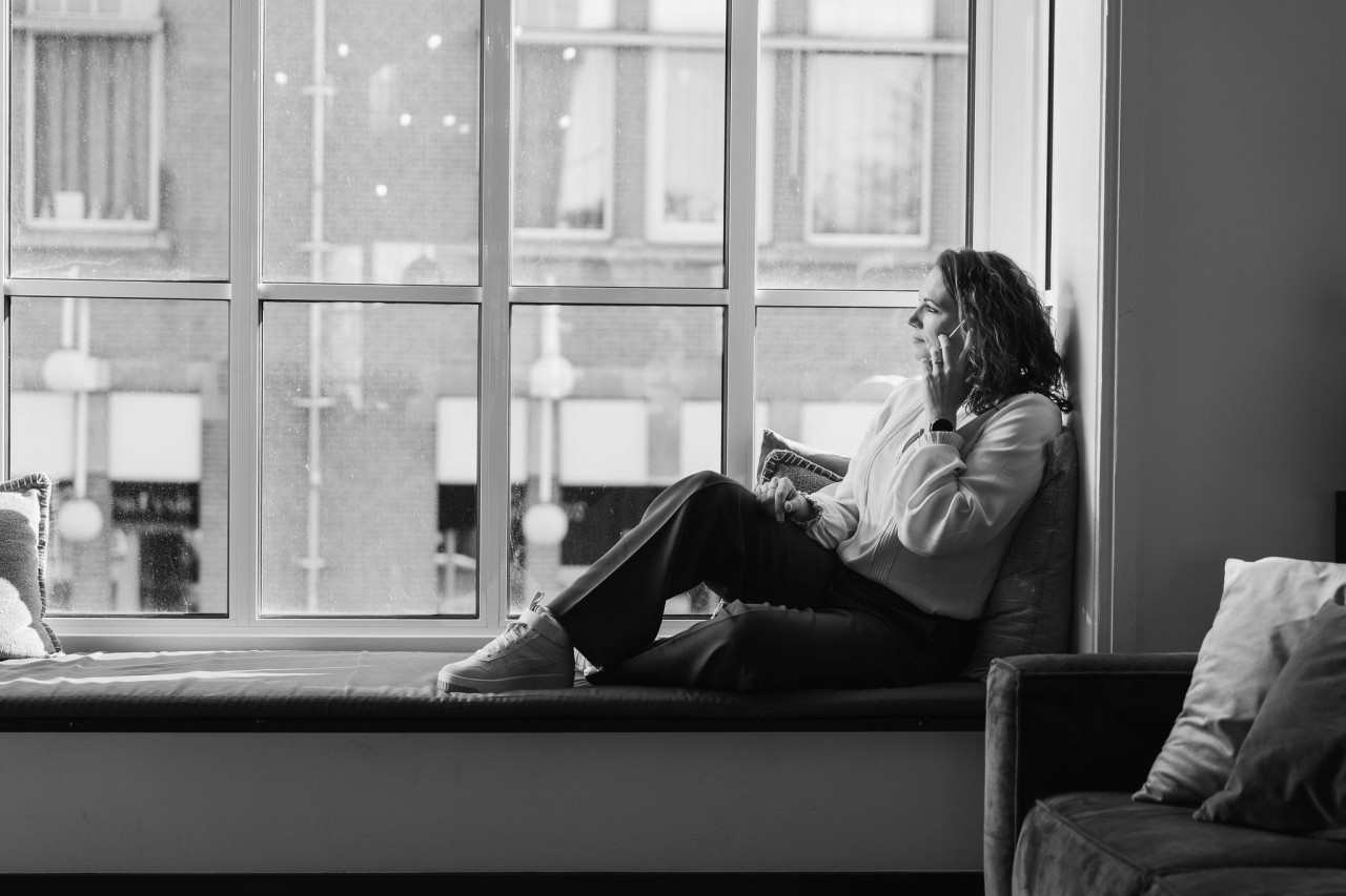 a group of people sitting around a table with laptops