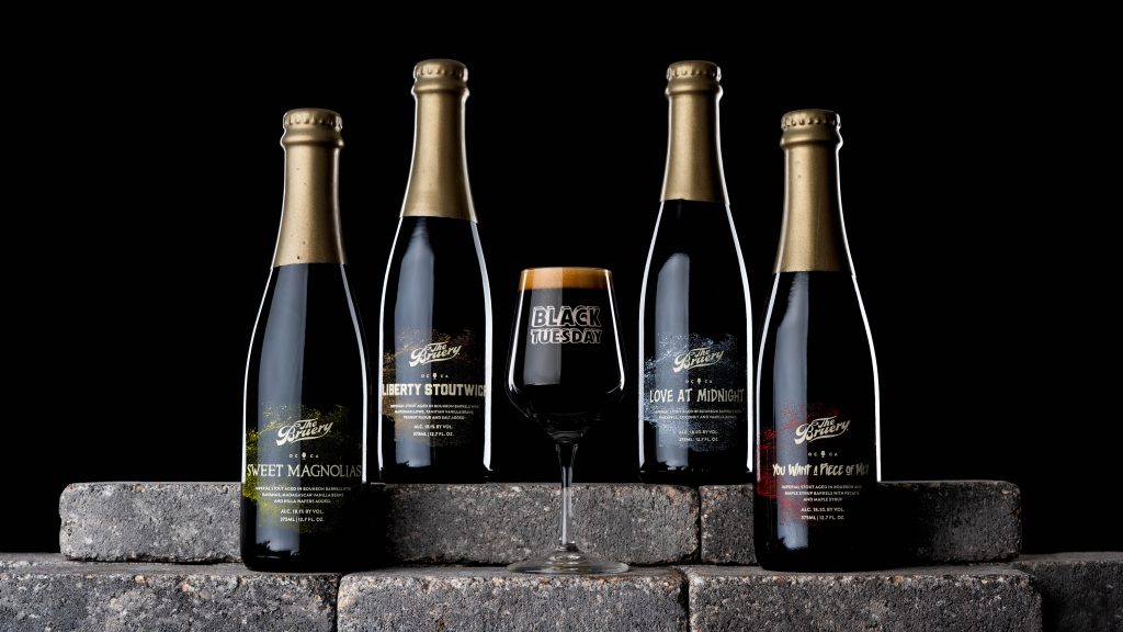 Black Tuesday beer bottle lineup on stone display