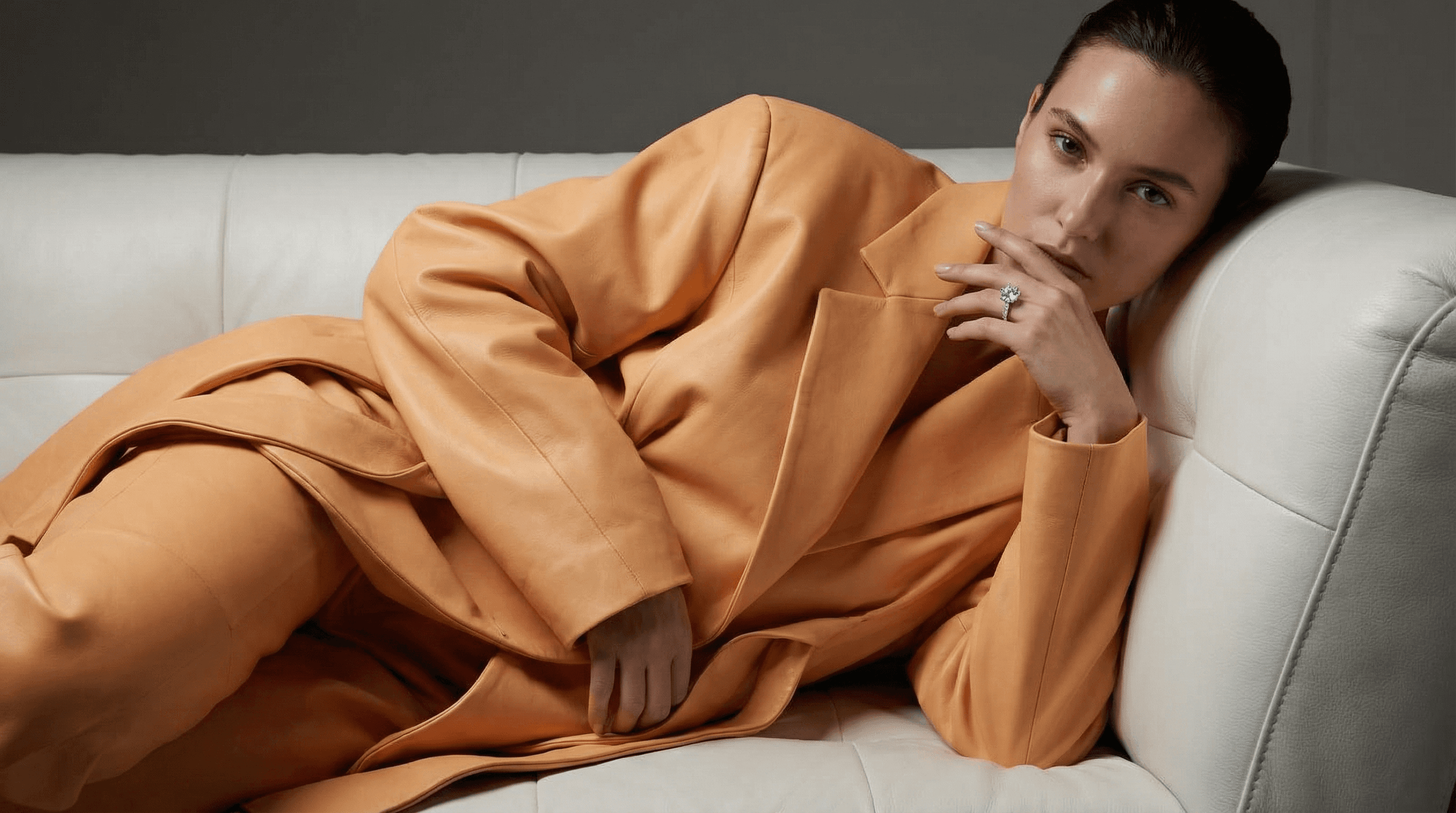 Close-up of two smiling friends with freckles, bright makeup, on a light blue background—joyful, inclusive brand portrait.