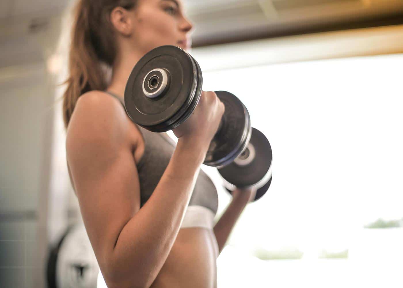Woman strength training with dumbbells