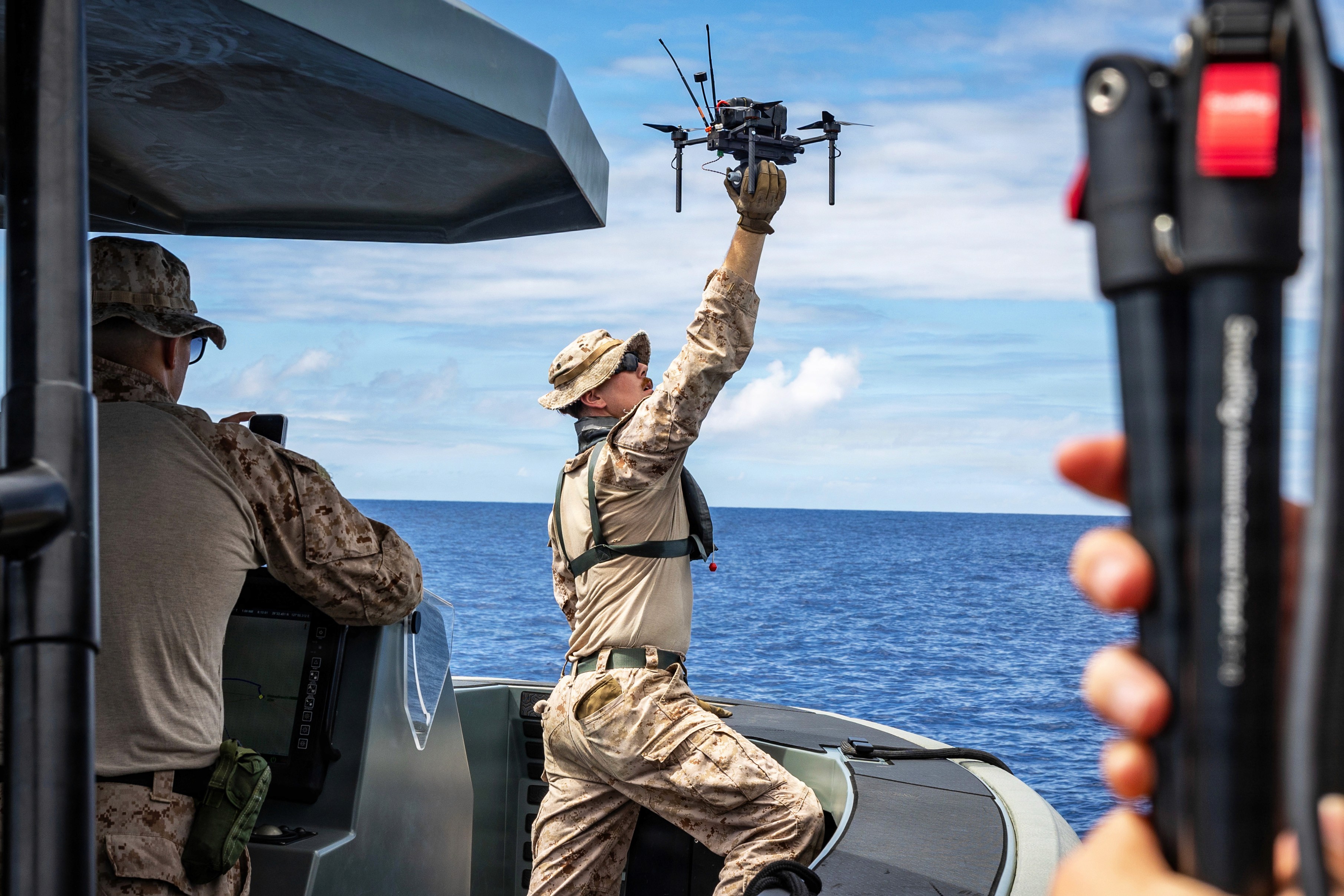 A Marine launches a Neros Archer first-person-view attack drone from a vessel off the coast of Okinawa, Japan