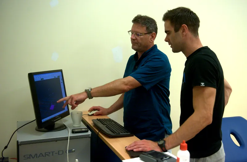 Researchers reviewing EMG and motion capture data on the BTS SMART-D system