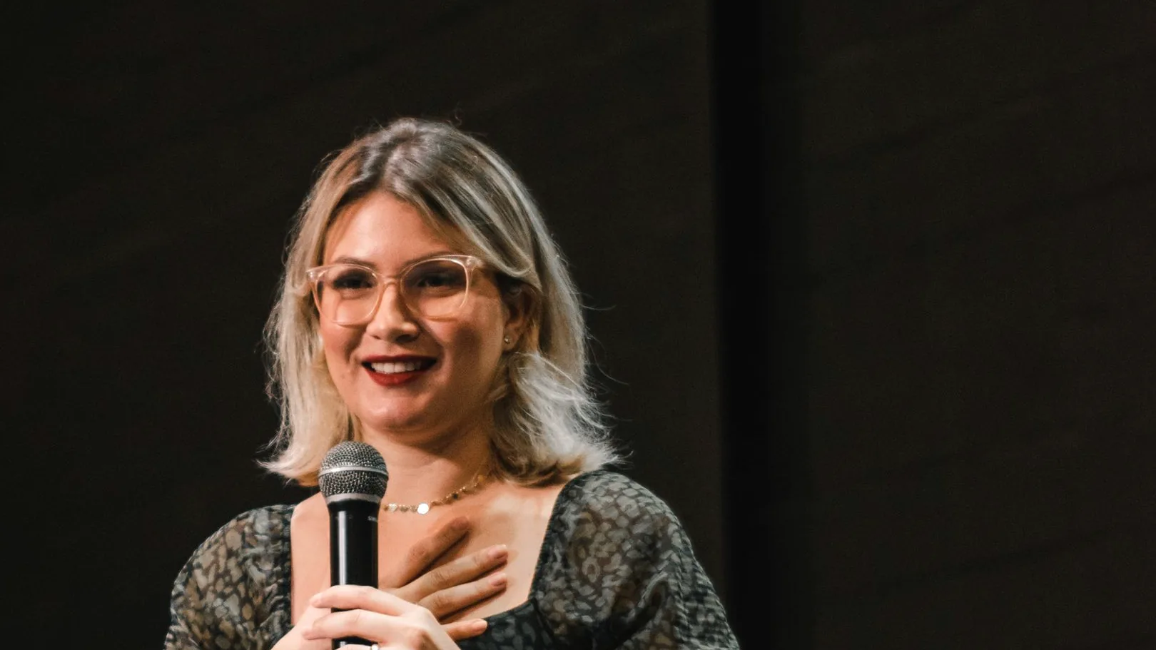 Hannah Lowell speaking on stage at Confluence Church