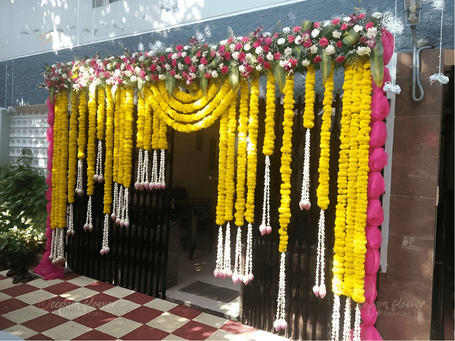 Home entrance decorated with real yellow marigold garlands & fresh flowers in Malviya Nagar, Saket, Rajouri Garden, Janakpuri