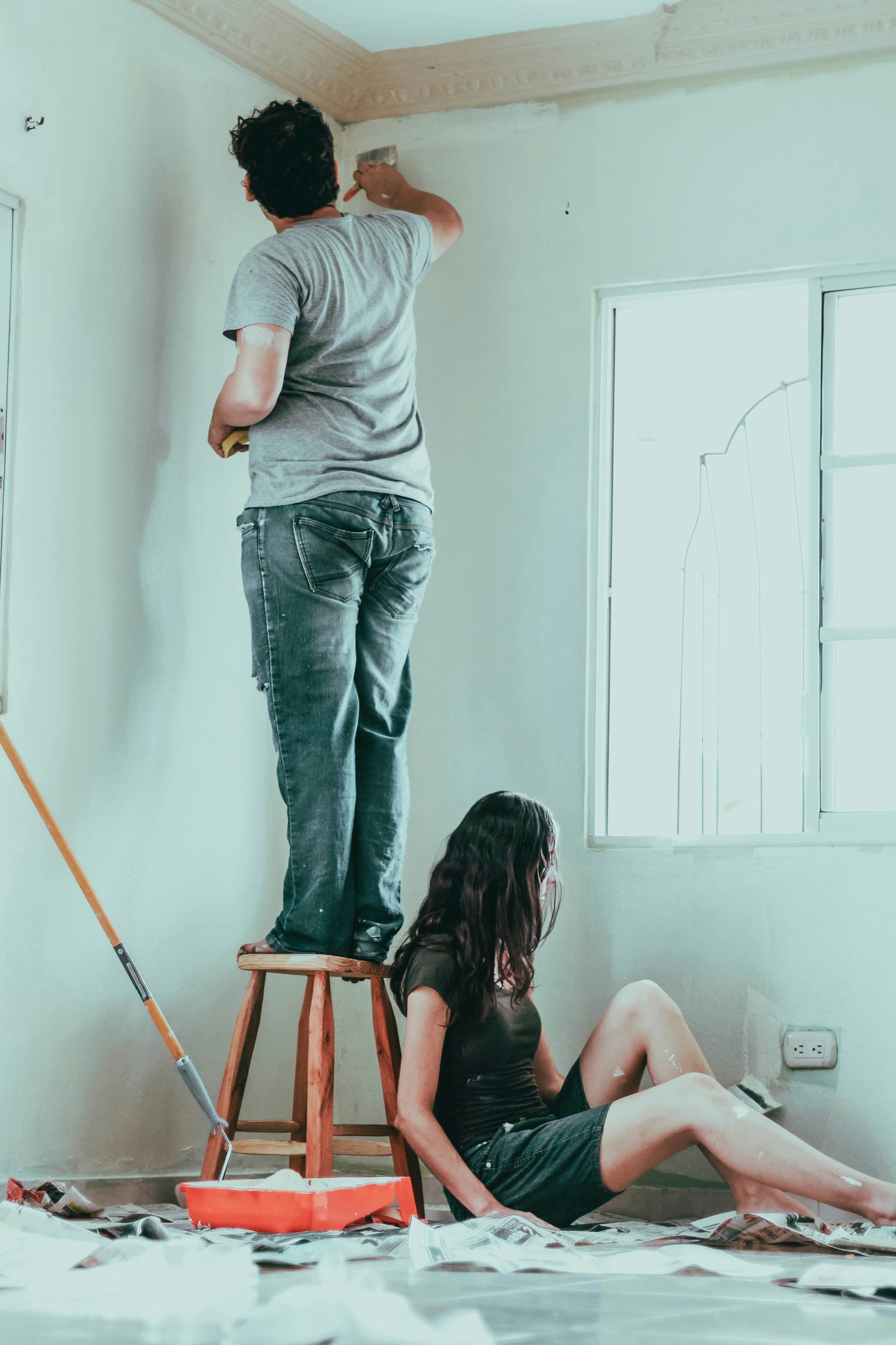 A person working on electrical repairs in a home setting.