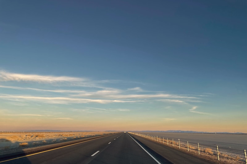 Long American highway stretching across a wide western landscape