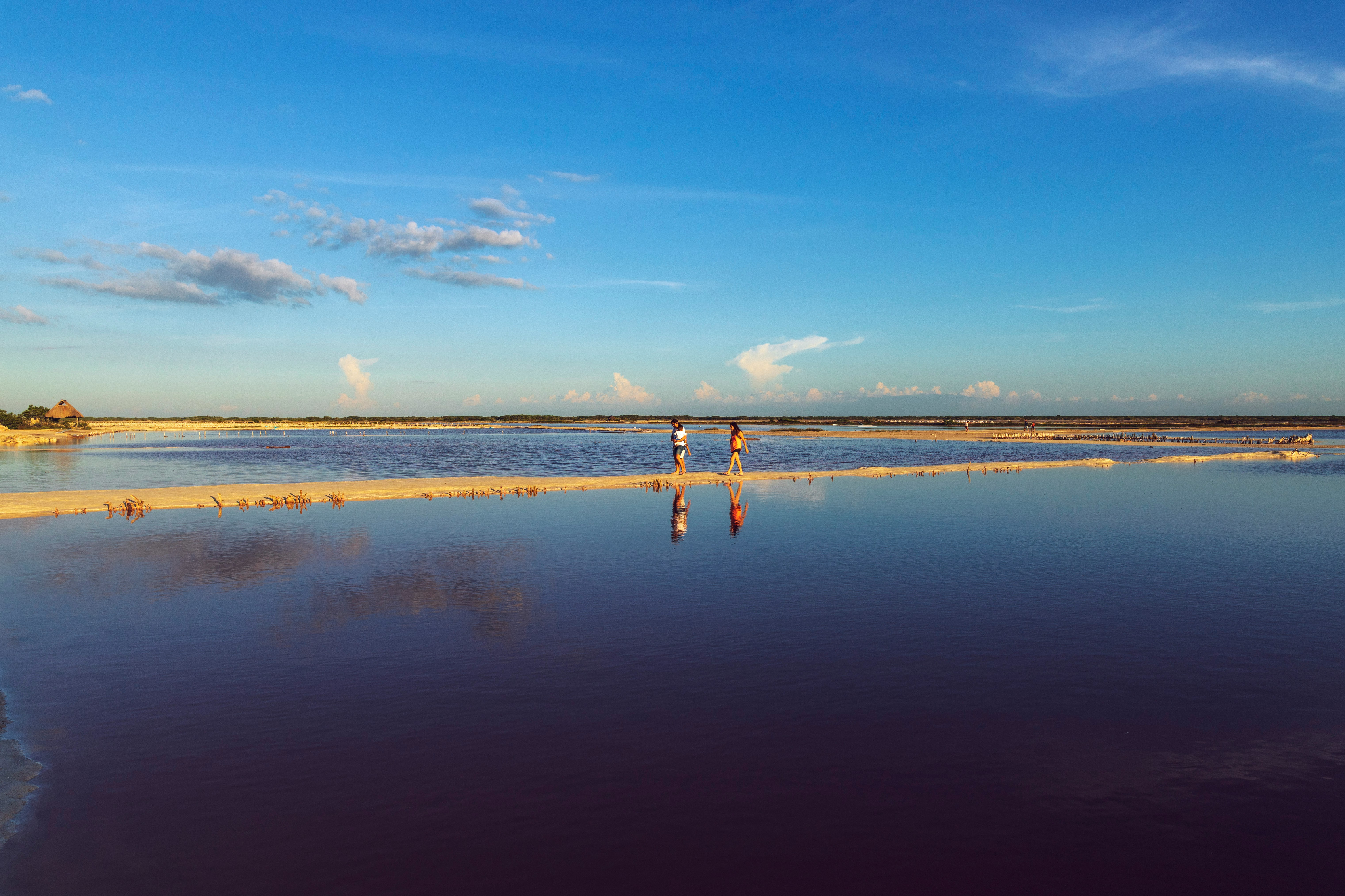 A light-filled fitness space with arched windows inside a coastal Mediterranean-modern villa, facing the ocean.