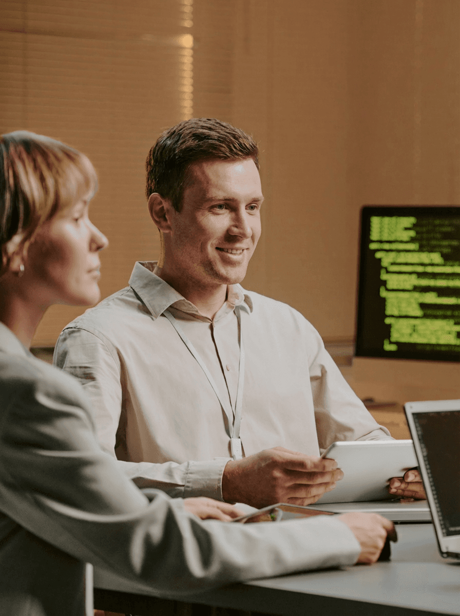 two ladies looking at a laptop and smiling