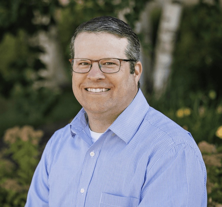 Tyler Wirth standing outdoors, wearing casual clothing.