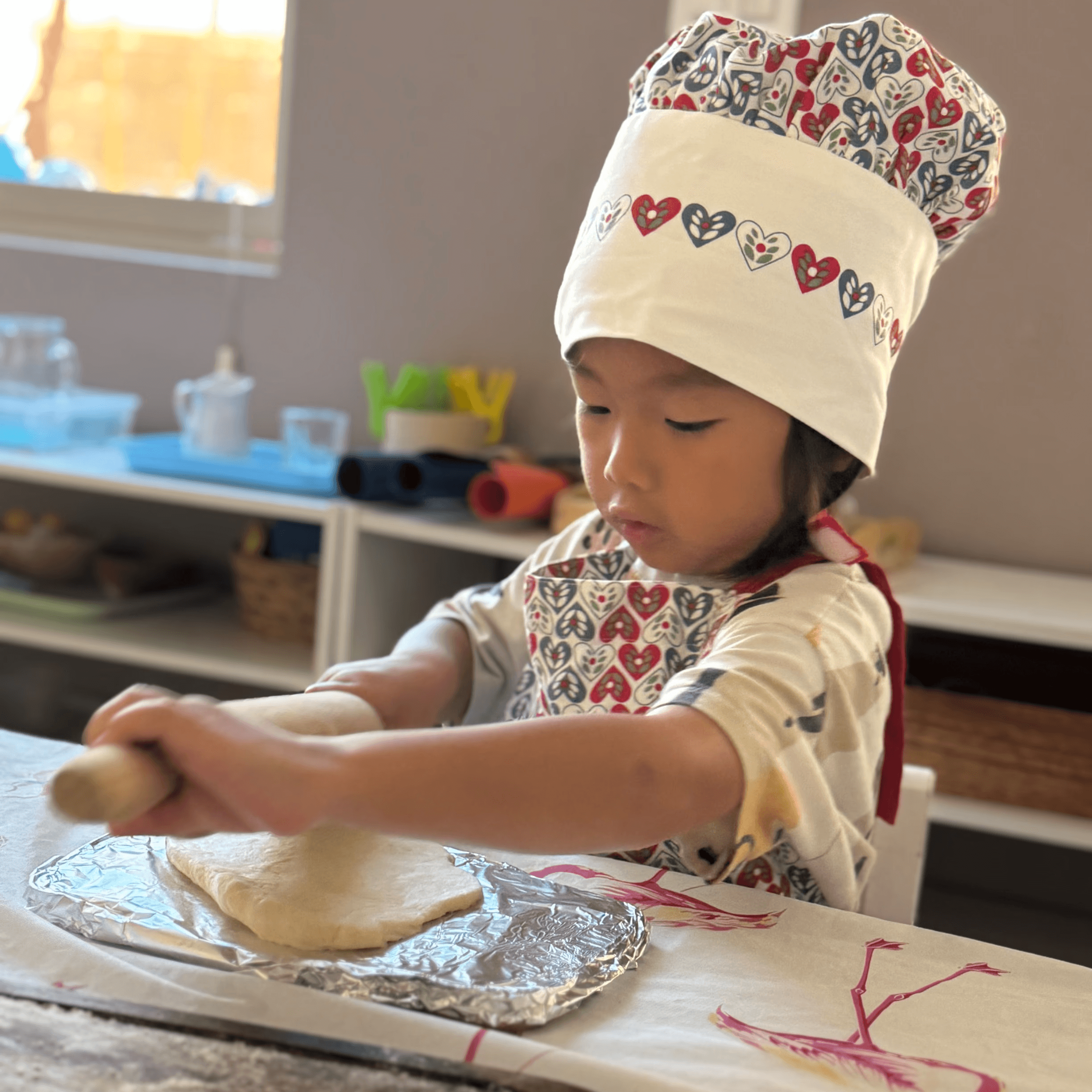 Montessori preschool student in Irvine preparing food independently as part of practical life activities