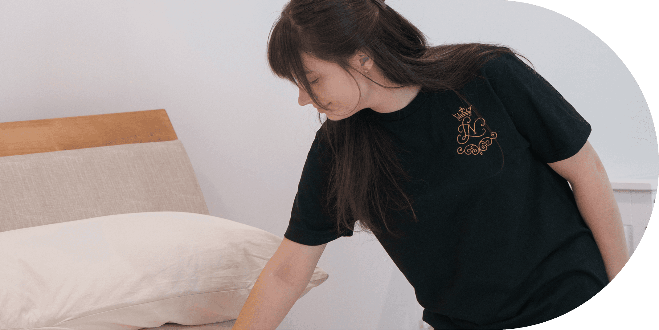 A cleaner is cleaning the bed.