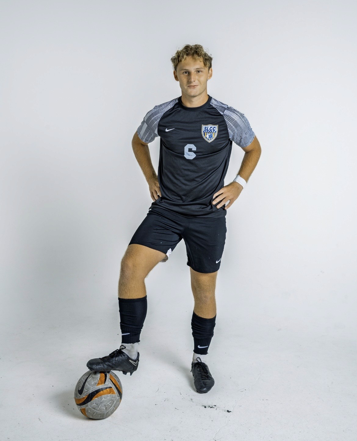 A young girl holding a tennis racquet on a tennis court