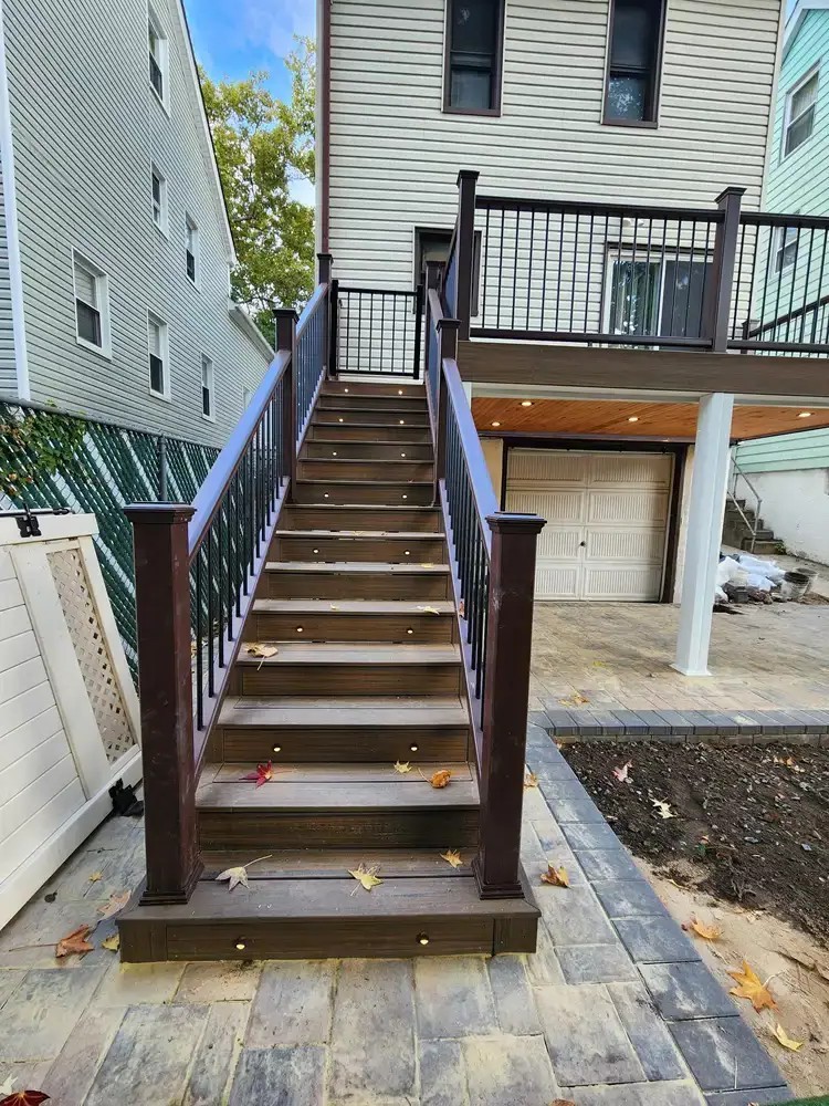 Trex composite deck stairs with picture framing, recessed lighting, and Transcend railings in Queens, NYC