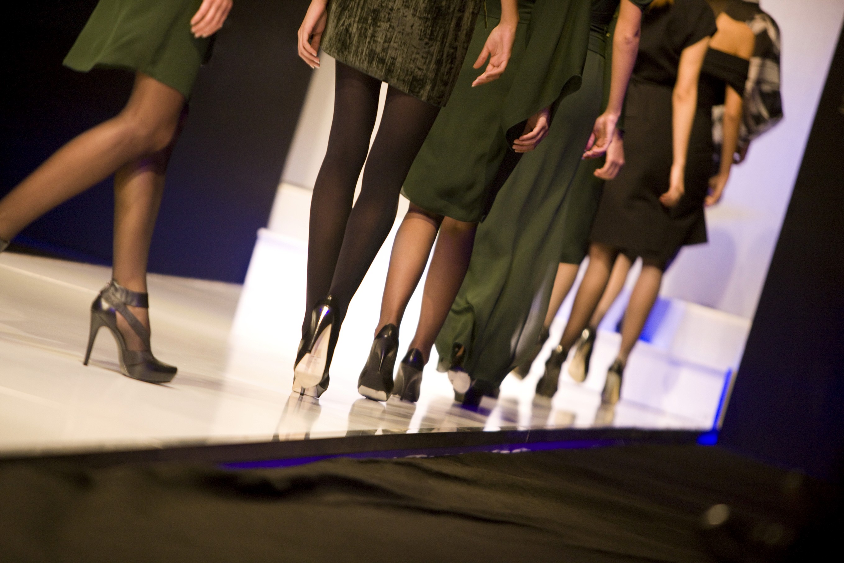 Black cosmetic product bottle against a dark background