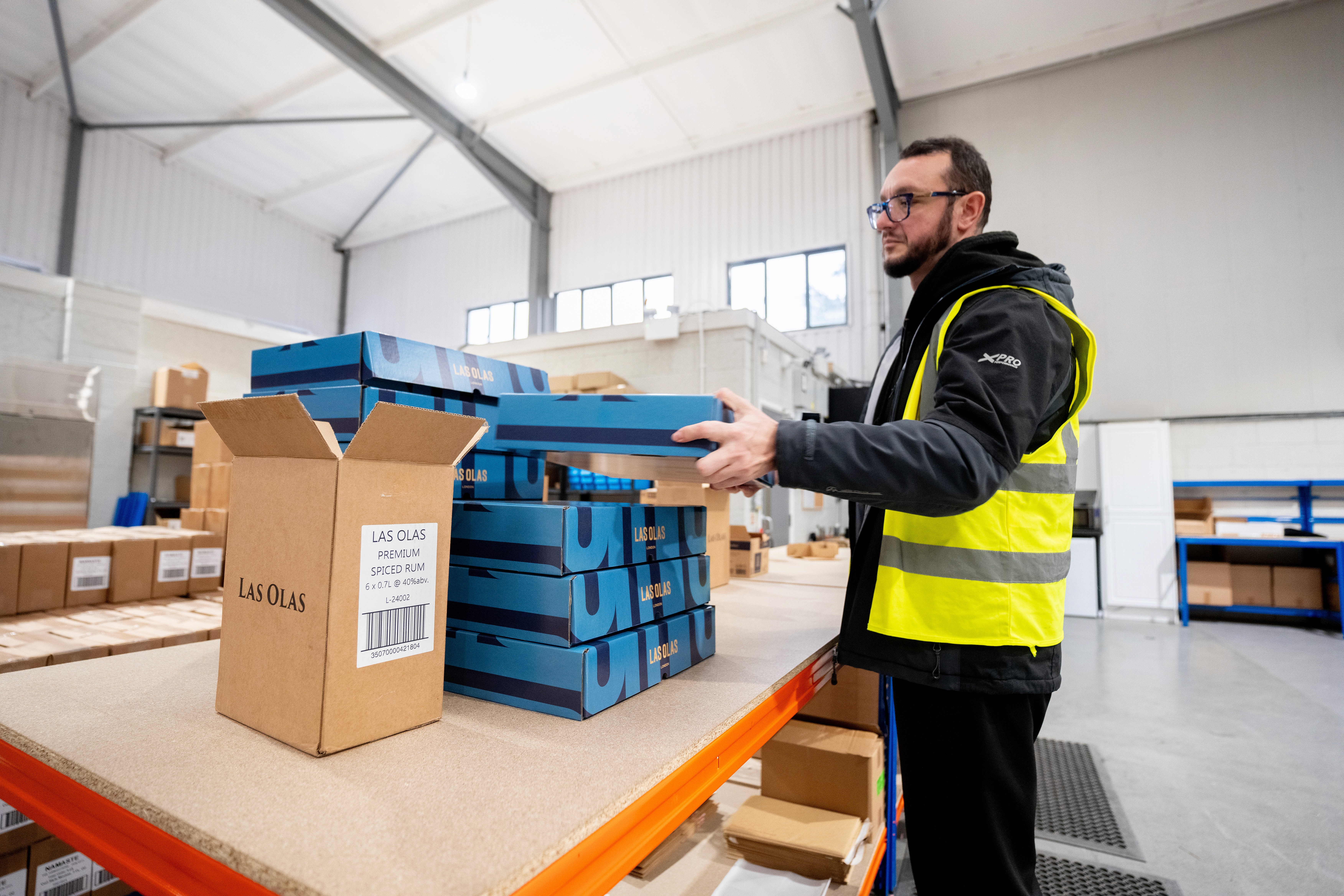a person kititng boxes in a warehouse