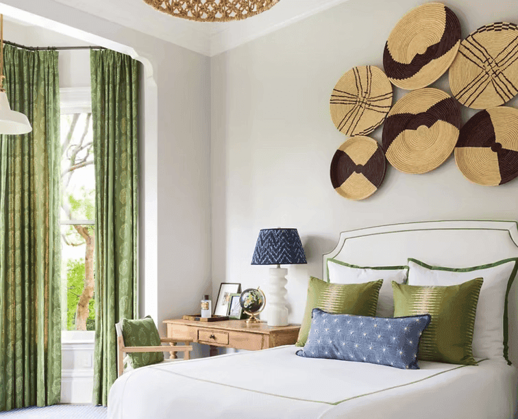 A person with short blonde hair holds a vintage camera.