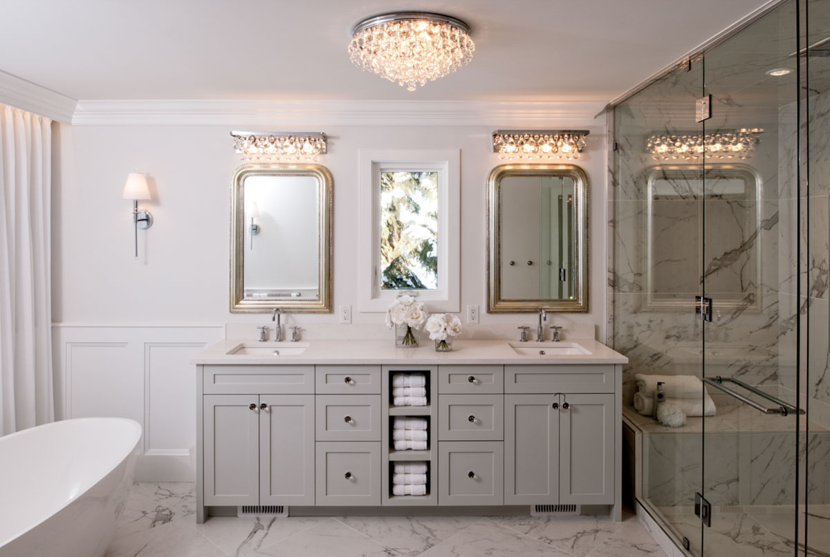 Image of Luxurious primary ensuite bathroom with marble flooring, double vanity, and spa-like shower by KHD Homes.