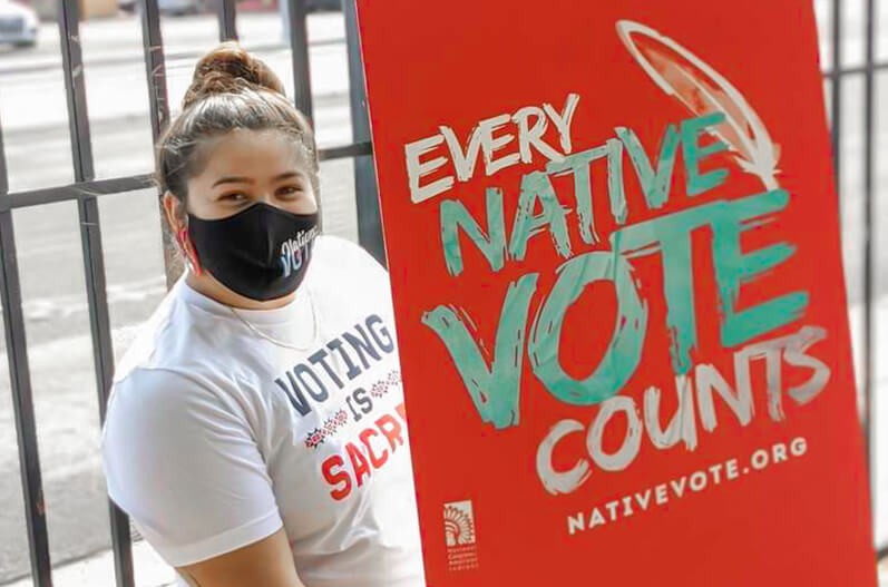 Every Native Vote Counts photo with girl in mask