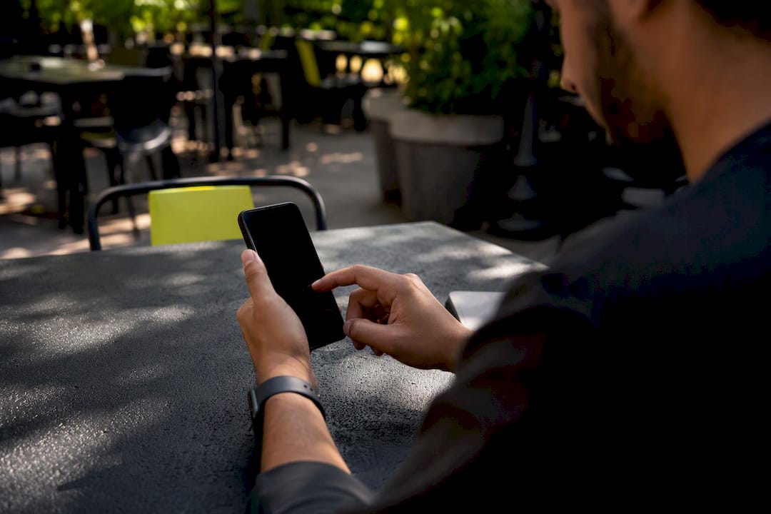 Hands setting social media schedule on smartphone