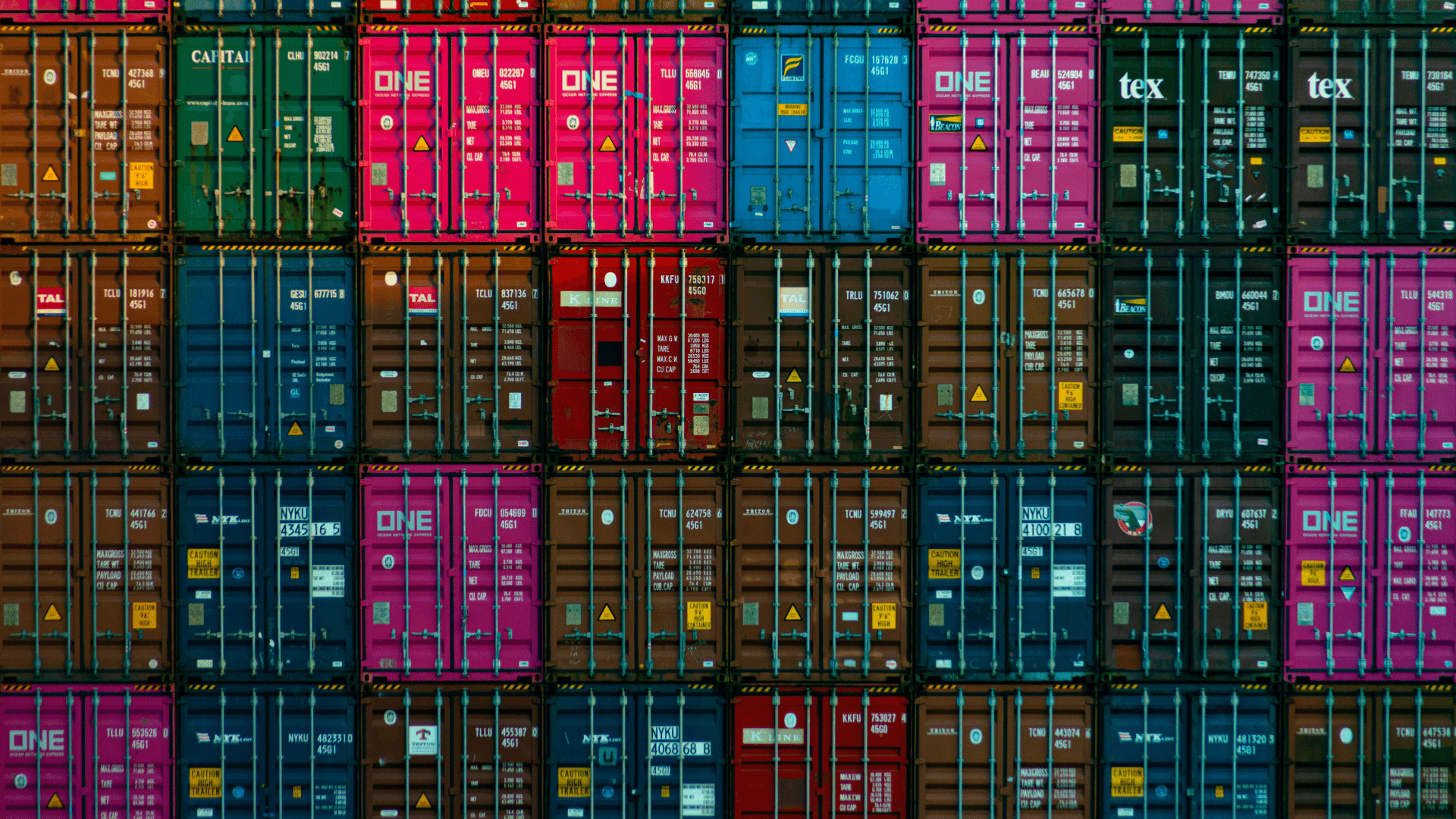 Numerous shipping crates stacked side by side and on top of each other