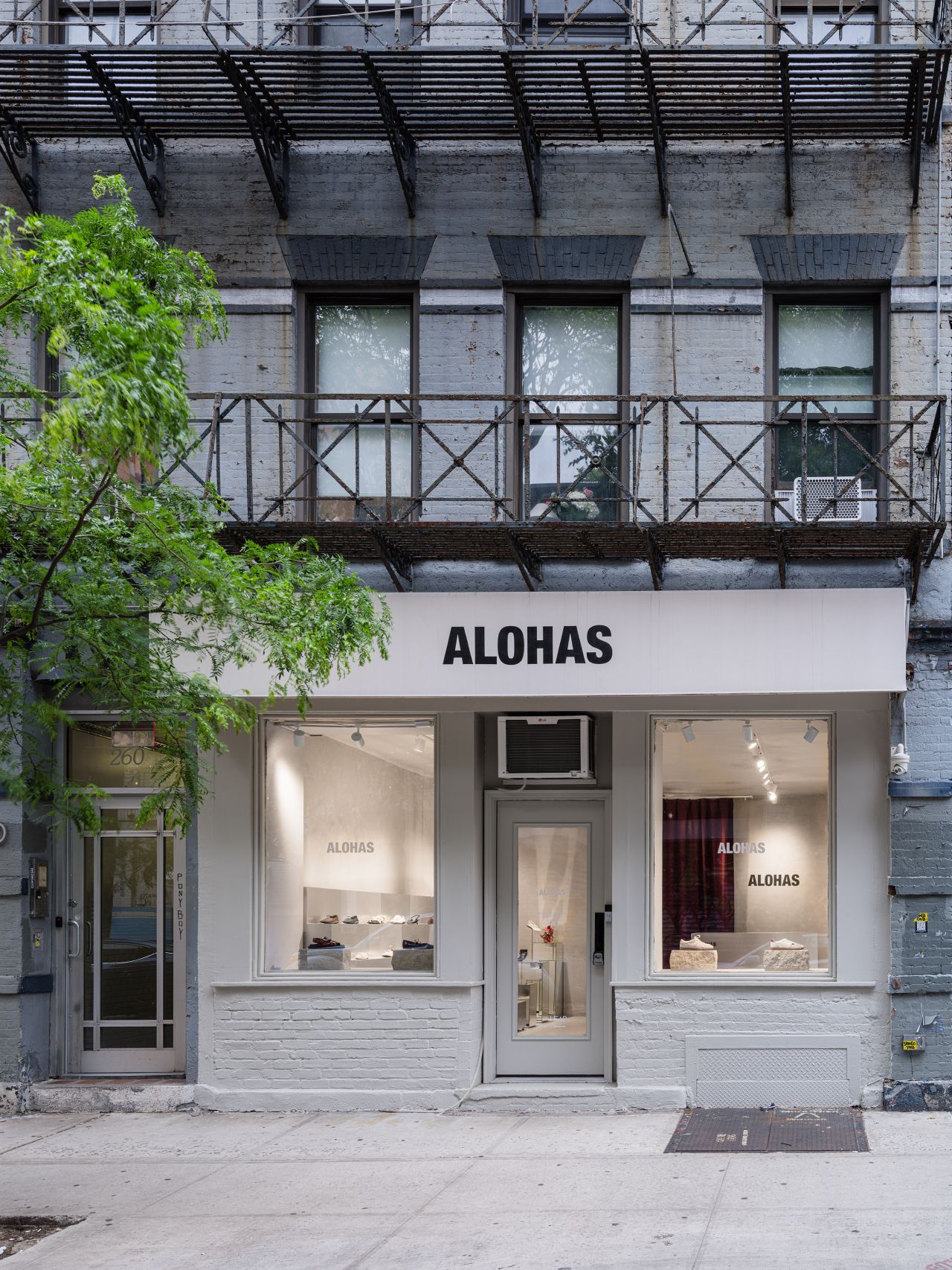 man in blue long sleeve shirt sitting on gray couch