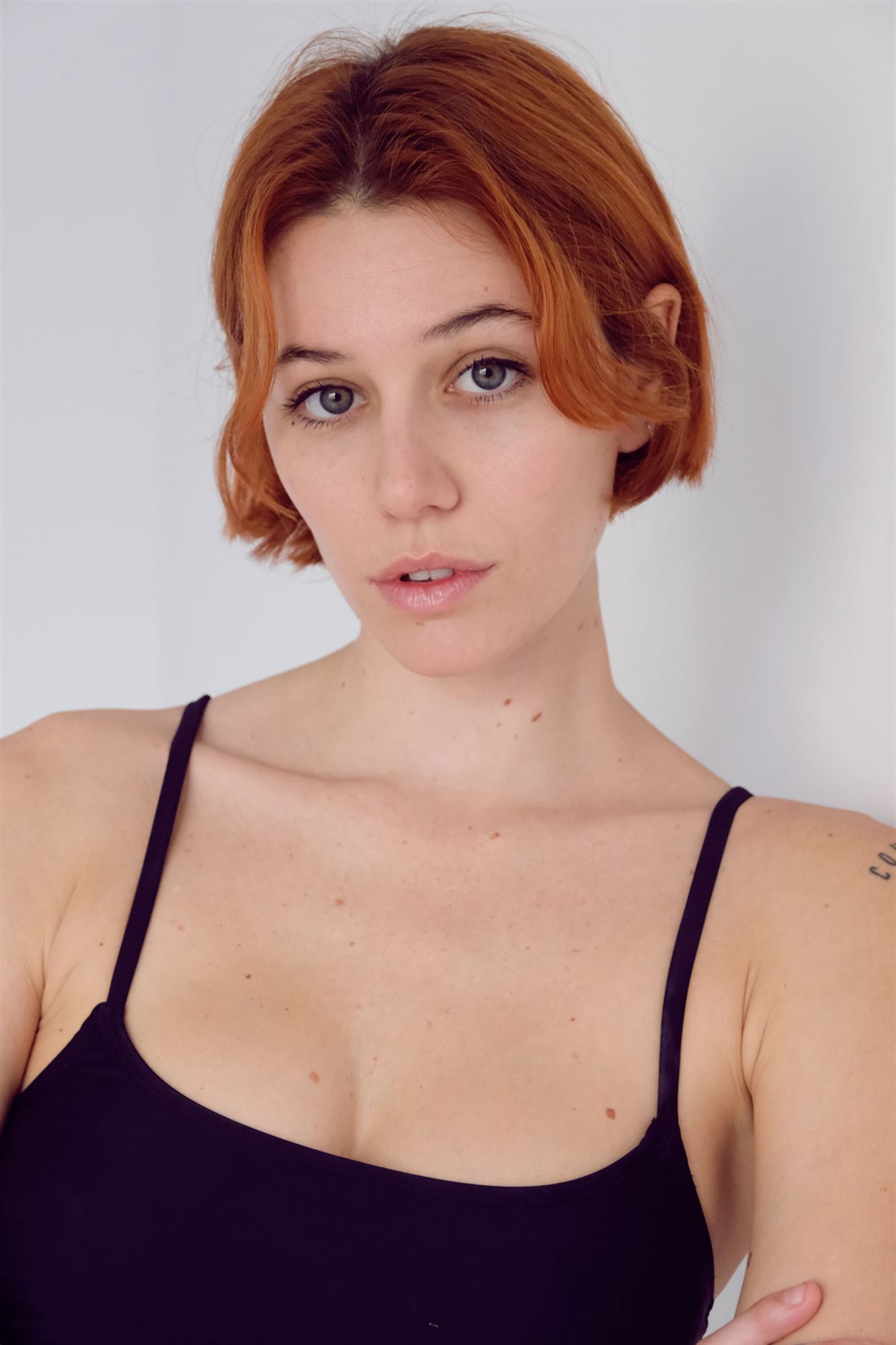 a woman with pink hair is posing for a picture