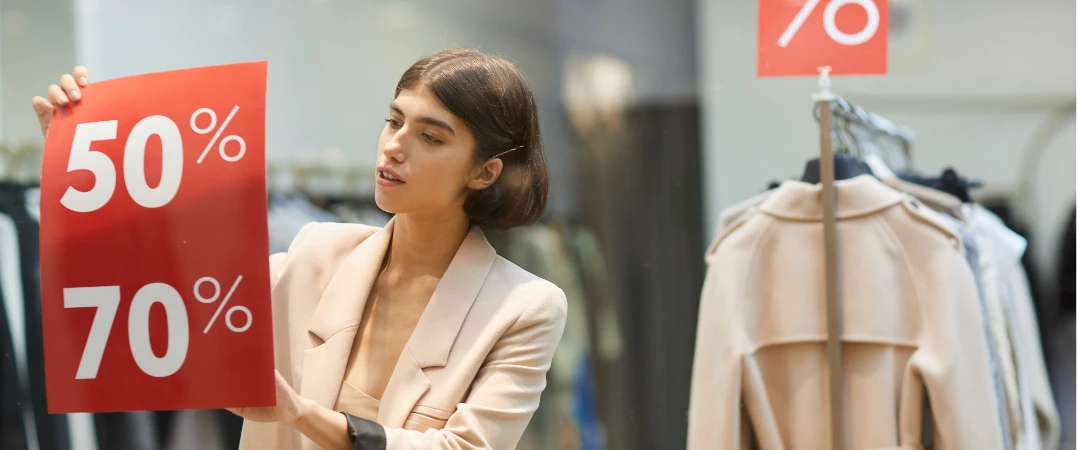 Two men discuss a project while standing at a laptop in an office.