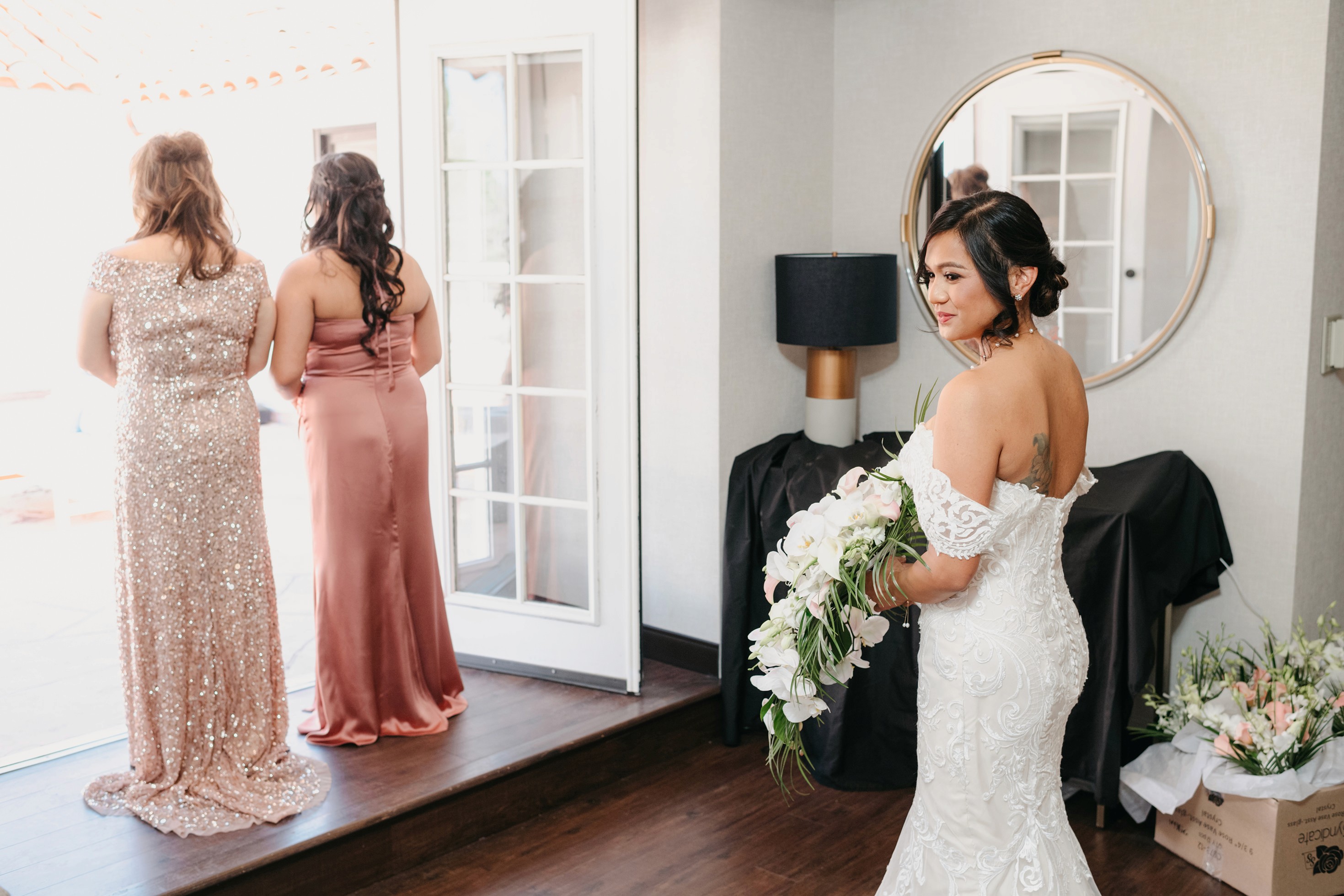 Flat lay wedding details with bouquet, rings, and sparkling bridal heels