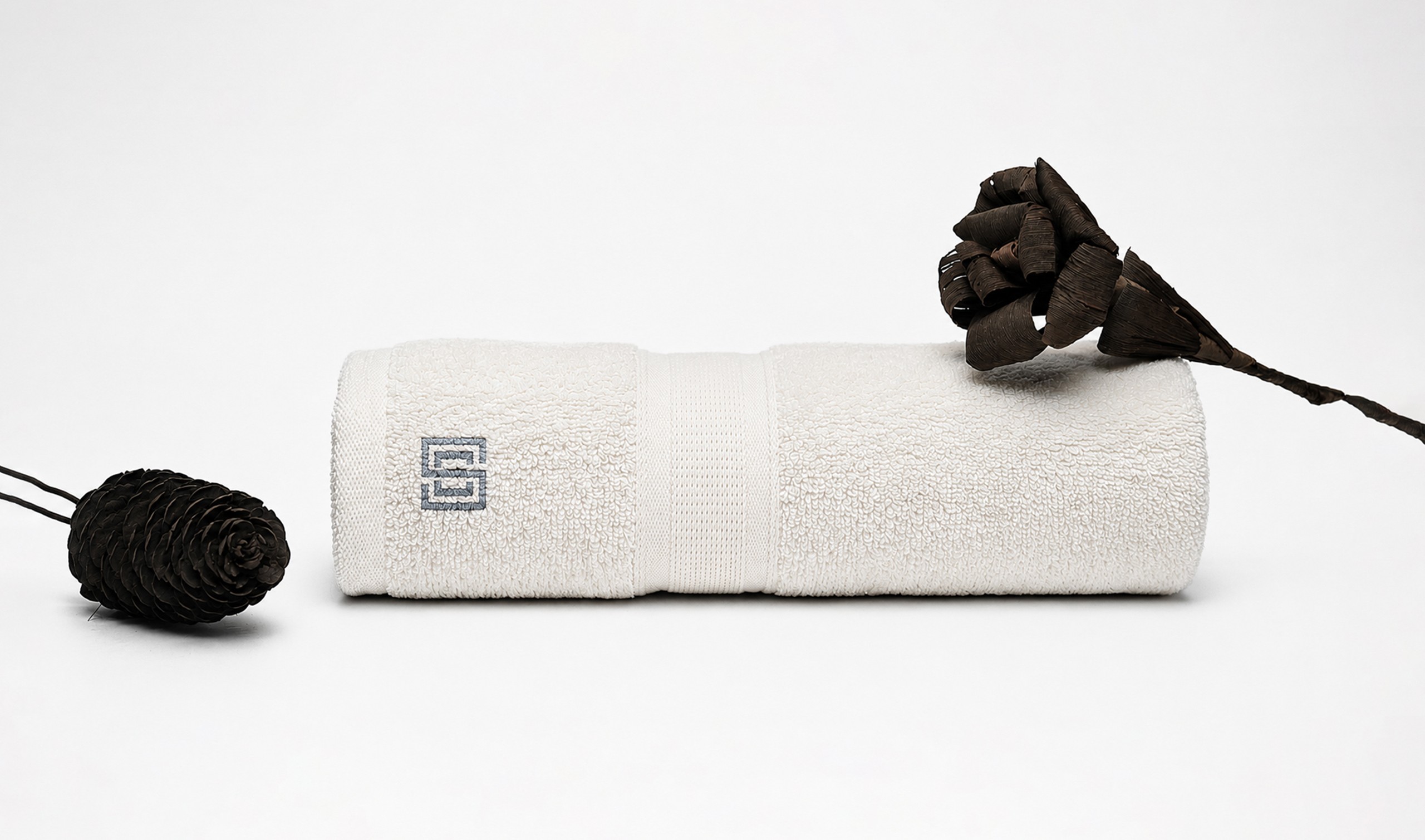 Cro Sea Villas branded amenities — premium towel and accessories art direction
