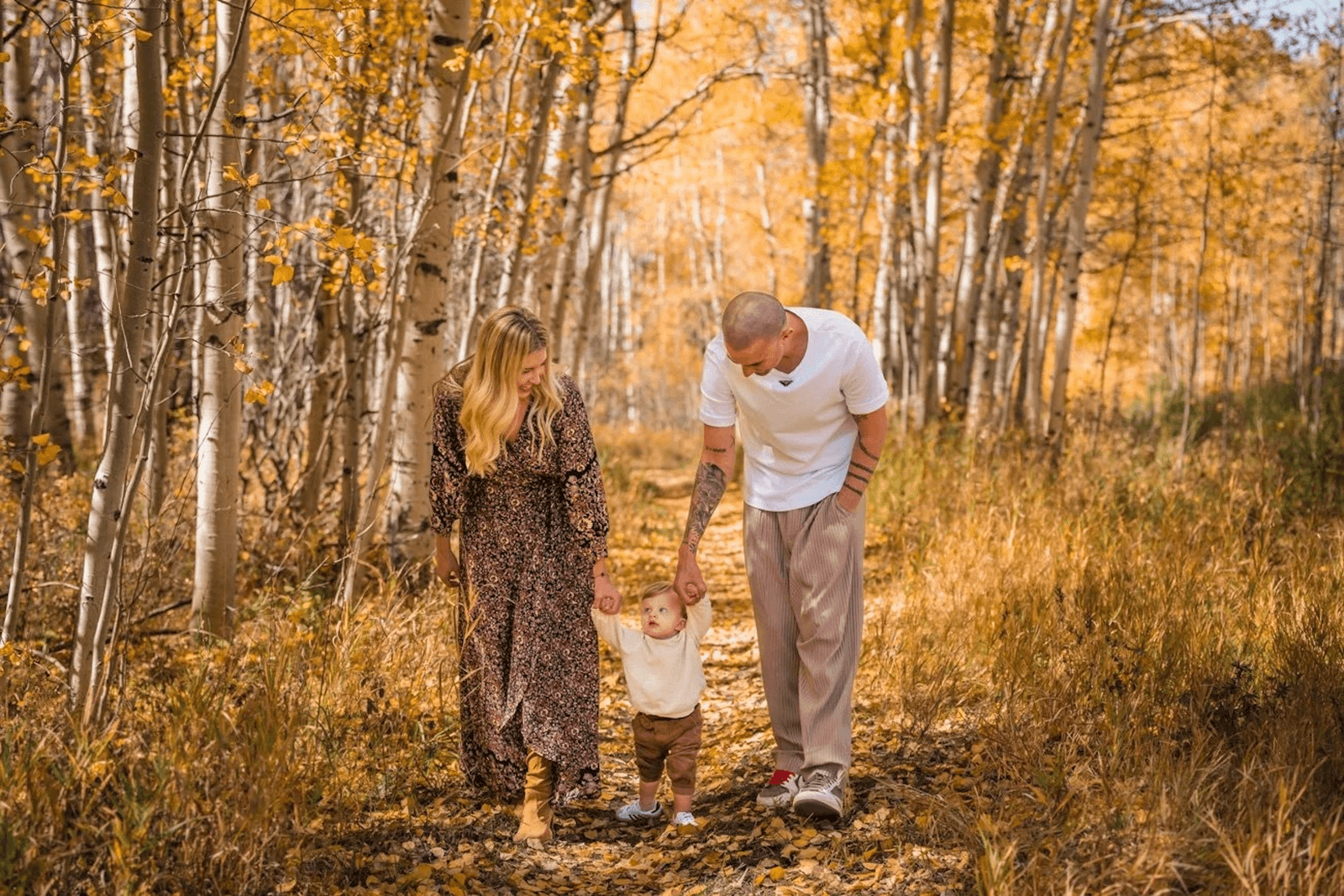 Family together among golden Aspen trees
