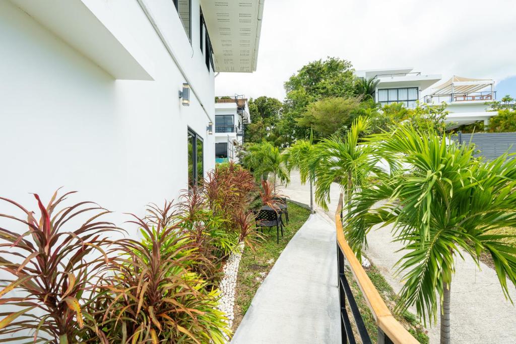 A light-filled fitness space with arched windows inside a coastal Mediterranean-modern villa, facing the ocean. 