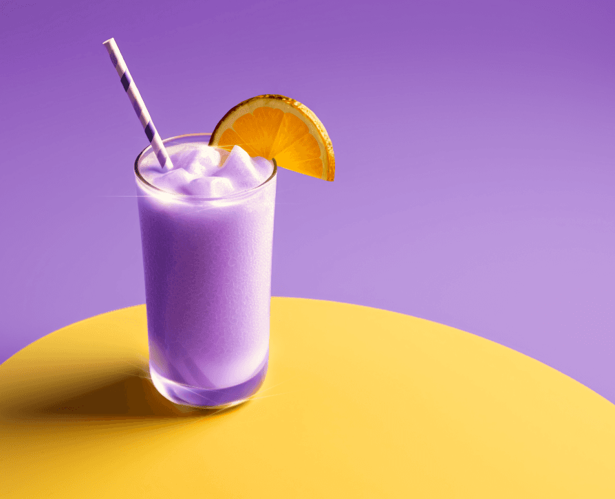 A glass of purple-colored frozen or blended drink