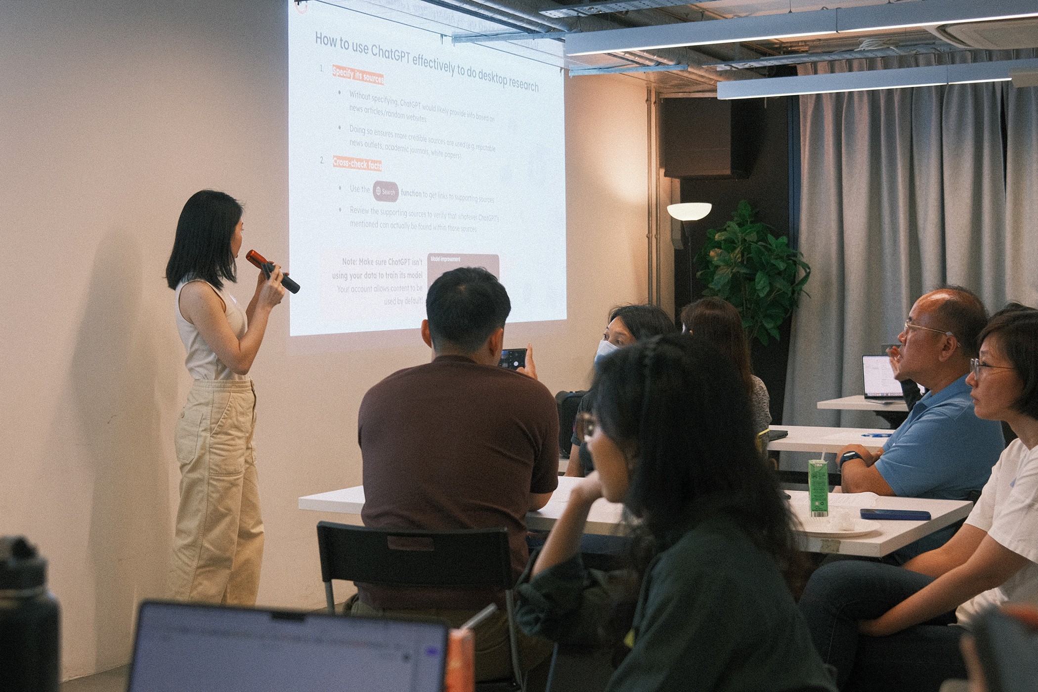 Participants looking at the projected screen while Lynn is presenting.