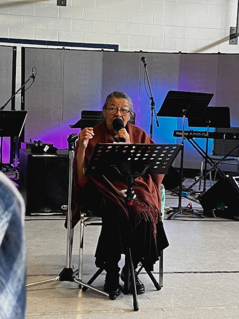 Indigenous woman speaking into a microphone