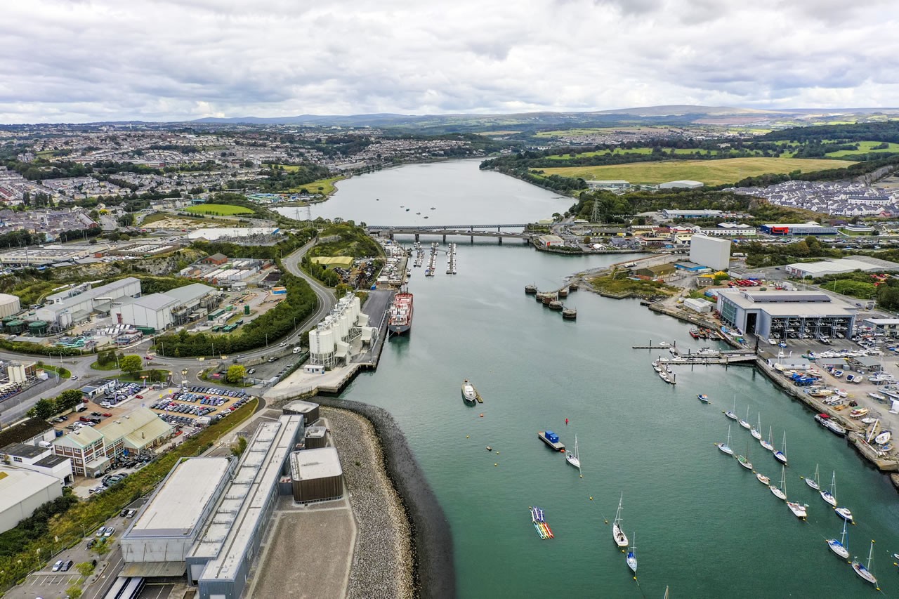 Blurred motion shot of a fast-moving delivery truck passing under a bridge at dusk