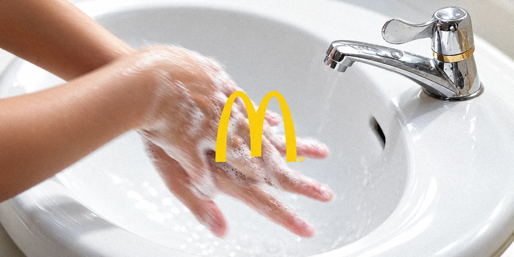 Close-up soapy hands washing forming McDonald's golden arches M logo in bathroom sink - 20 seconds can't skip handwash ad