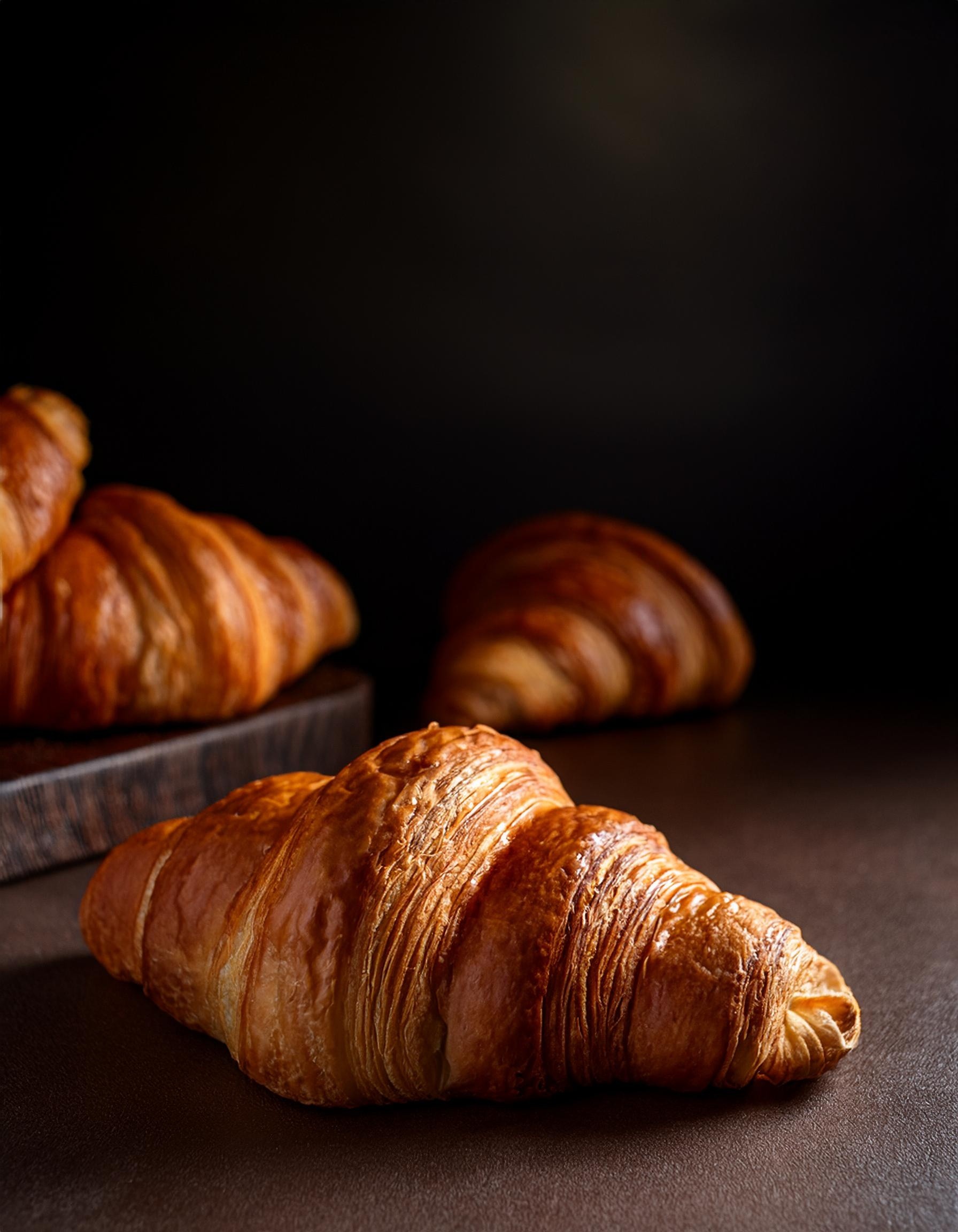 Classic French Croissant with golden pull-apart layers and a soft buttery interior at Café Sherpa's, Brookfield WI. Made fresh daily with classic laminated dough.