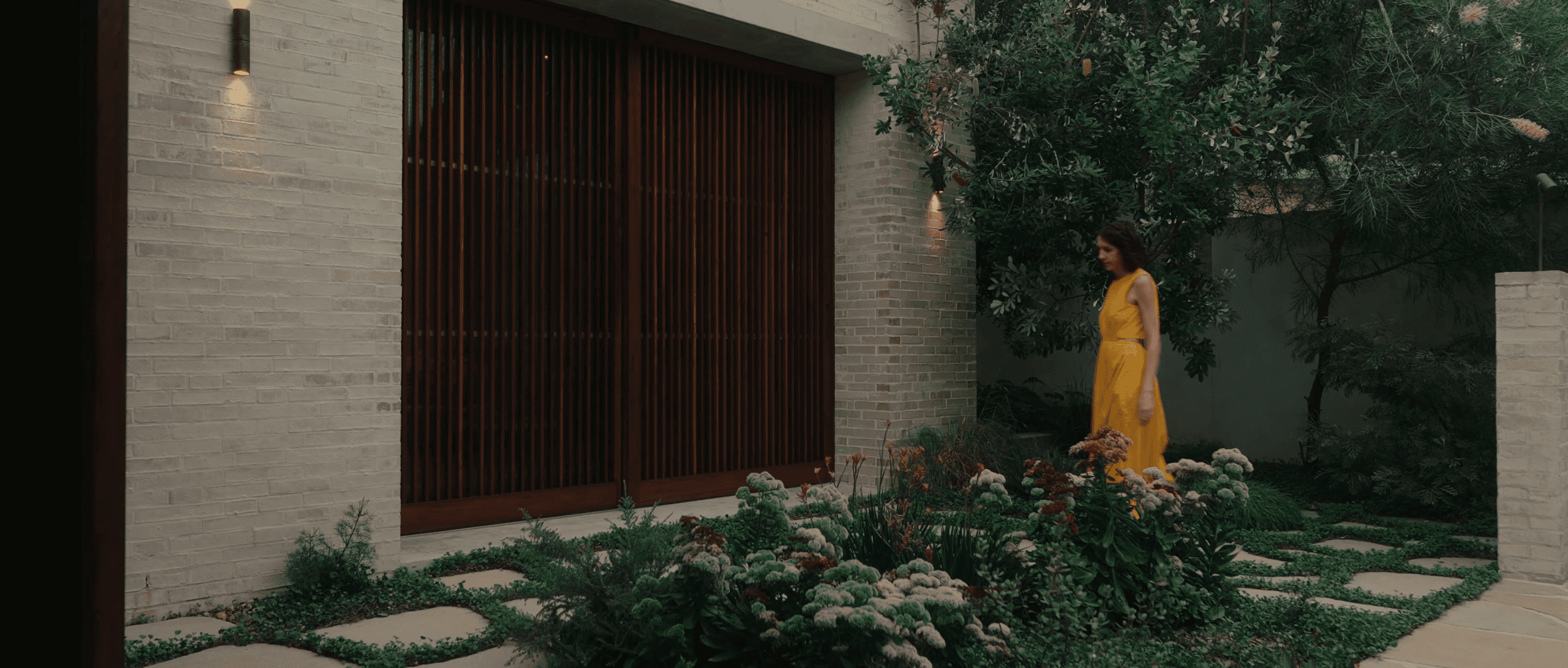 Jennifer McMaster walking through garden 