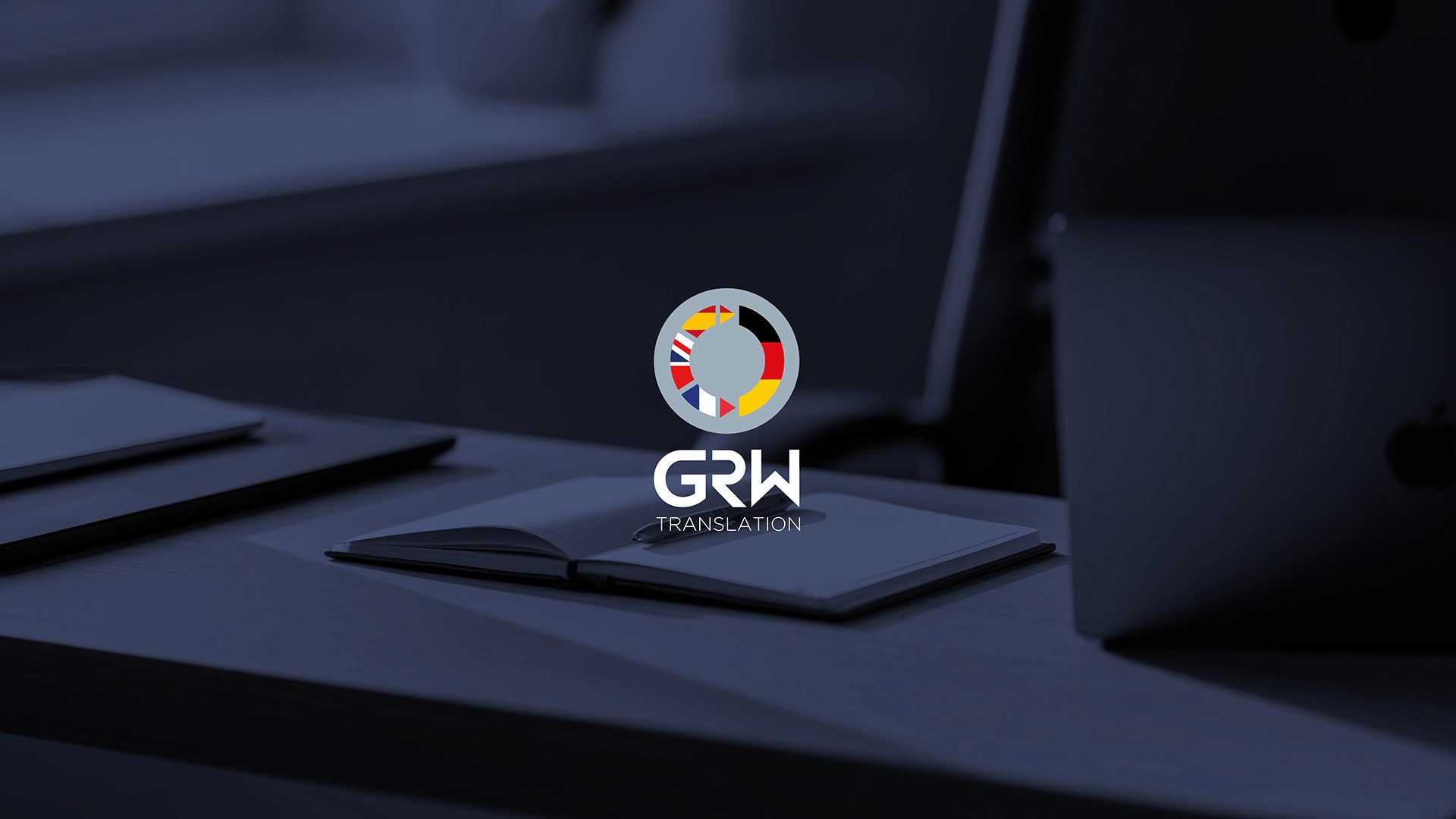 GRW Translation logo and brand identity design on desk background by Huw Mathias graphic designer London