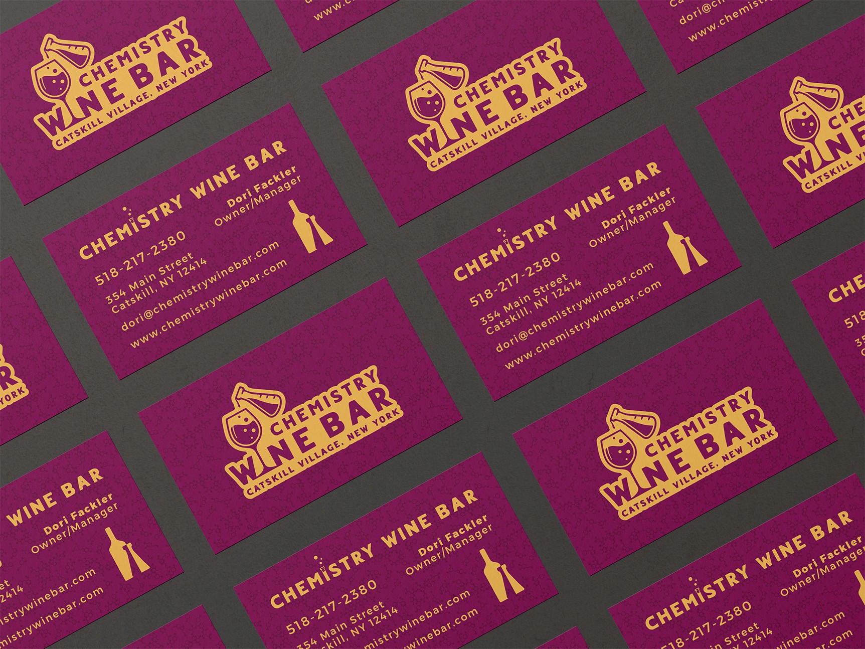 Graphic design mockup of business cards for Chemistry Wine Bar — bold, wordmark style logo with decorative sans serif typography, designed by Will Lefkovich.