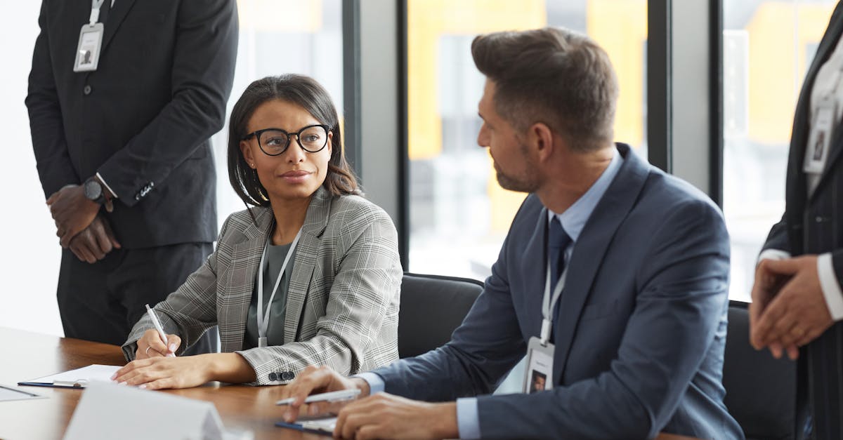 Diverse business professionals discussing strategy during a modern board meeting.