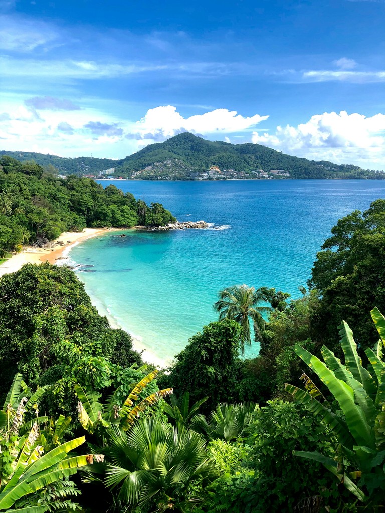 a view of a tropical beach from a hill
