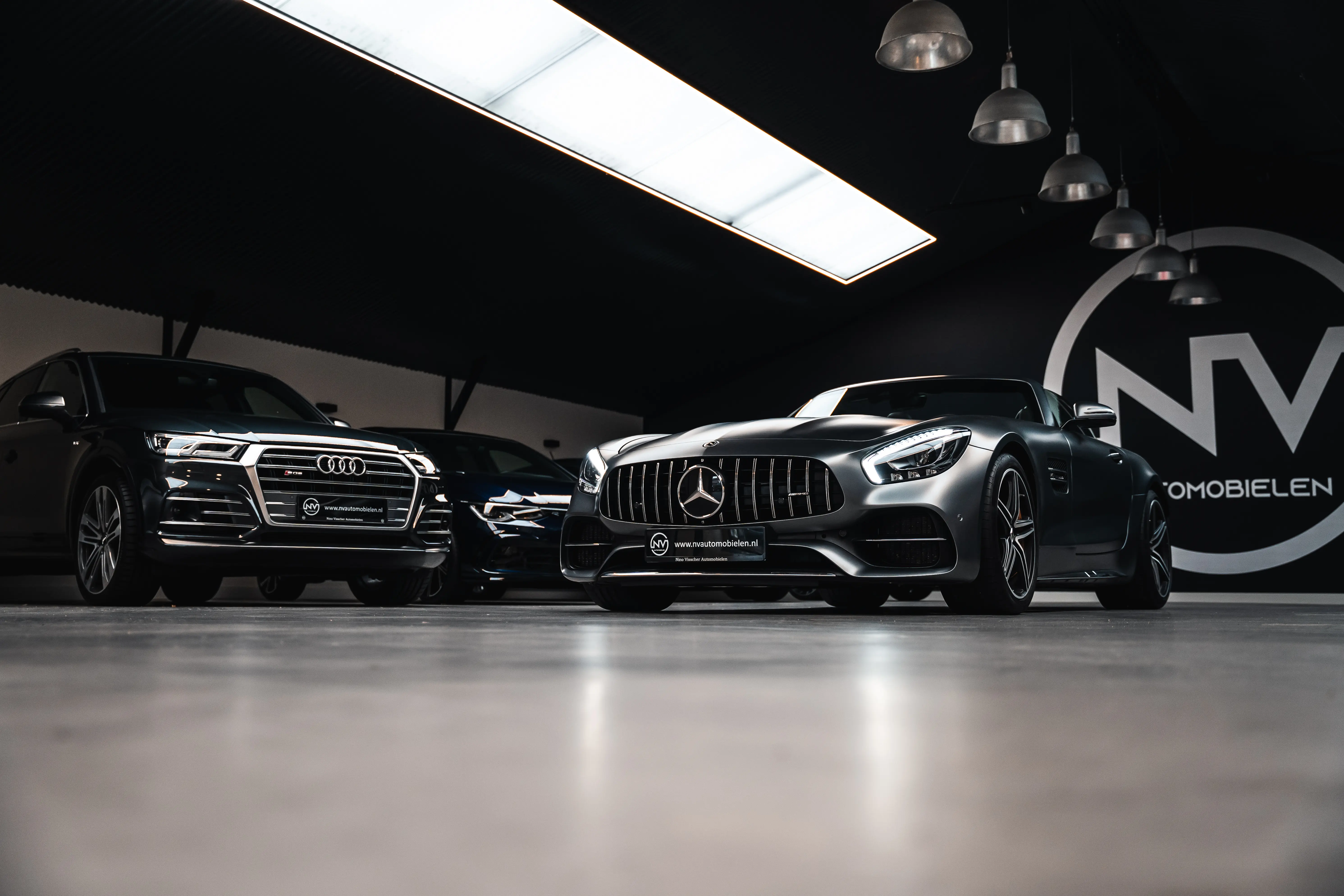 Garage full with high-end cars like Mercedes-Benz and Audi