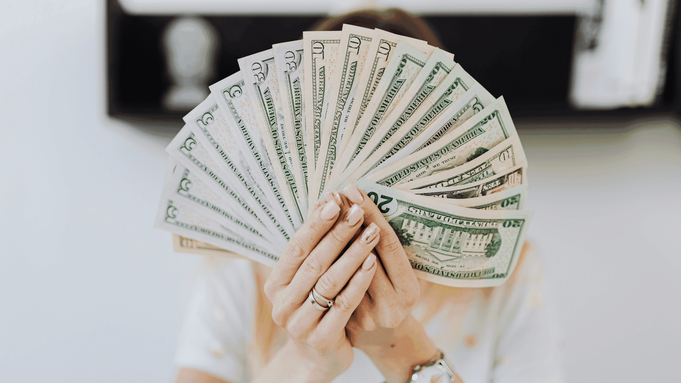 US dollars spread by hands