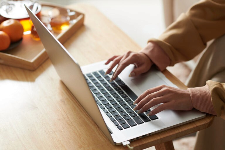 Person working on a laptop, protected with EMF shielding pad