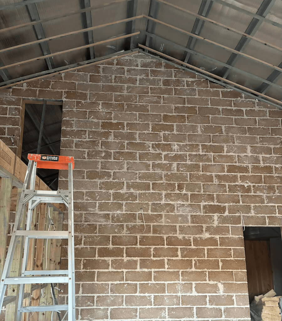 A photo shows the structure of the hempcrete block on the wall. 