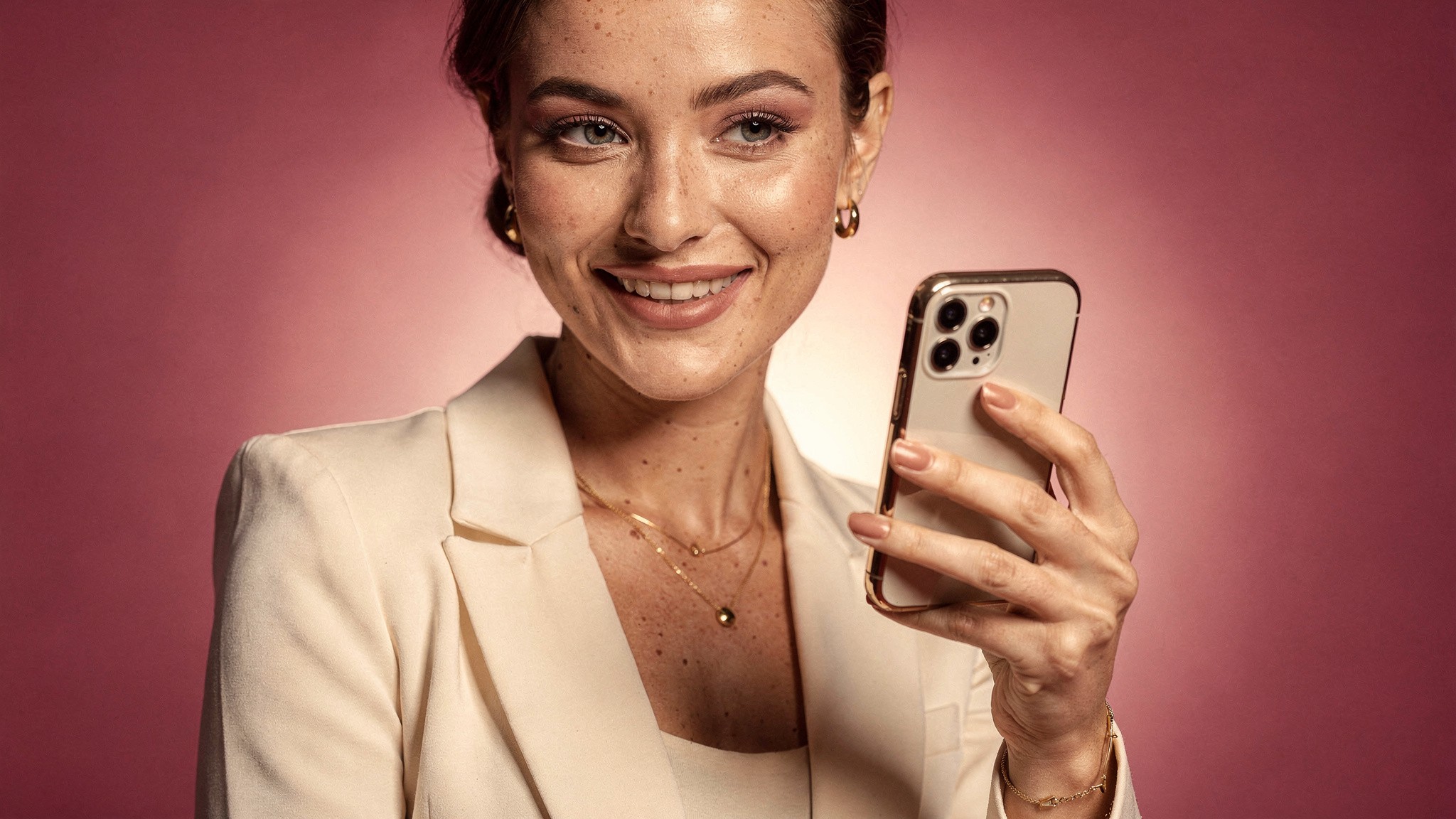 Creator smiling while sharing a post from her phone